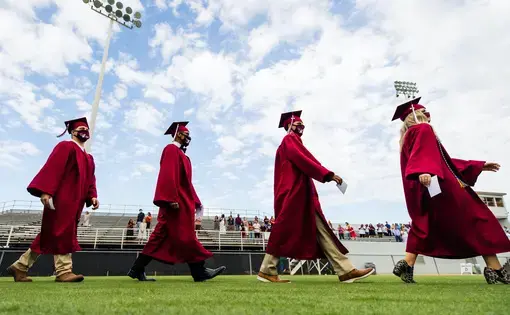 In Sherman, Texas, high school students wearing masks participate in a socially-distanced commencement ceremony. Image by&nbsp;Sara Carpenter / Shutterstock. United States, 2020.