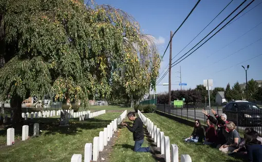 Tlingit elder Bob Sam says a prayer at the gravesite of a Native Alaskan child who died while attending the Carlisle Indian Industrial School in Pennsylvania. Last month marked the 100th anniversary of the closing of Carlisle, which was the first government off-reservation Indian boarding school in the United States—it would become the model for future boarding schools throughout the U.S. and Canada. Roughly 12,000 Native children attended, many of whom were taken from their families and communities by…