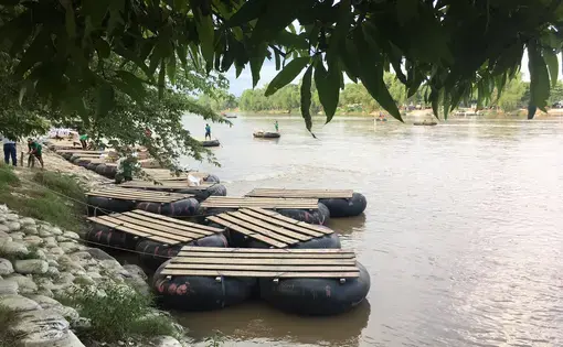 Rafts on the bank of the Suchiate River, which runs between Guatemala and Mexico. These rafts—largely ferrying market-goers and vendors—are also frequently used by U.S.-bound migrants crossing into Mexico. Image by Lauren Markham. Guatemala, 2018.