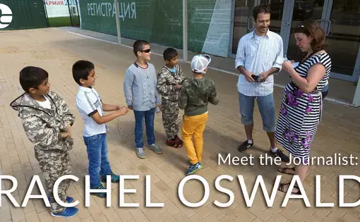 Pulitzer fellow Rachel Oswald and her fixer, Dmitry Saltykovsky, interview Russian-Tajik boys attending Patriot Park, a government-funded permanent exhibition outside of Moscow designed to showcase Russian military strength. Image by Ulia Zamiatina. Russia, 2016.