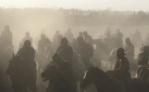 Competitors battle for control of a calf at a buzkashi event in northern Afghanistan. March 2017. Image by Jason Motlagh.