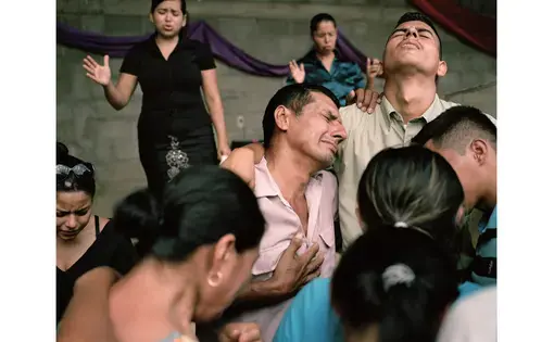 A local pastor and congregants comfort Darwin Franco’s family at a funeral in Correderos. Image by Dominic Bracco II. Honduras, 2013. Media file: website_canvas_honduras10.jpg