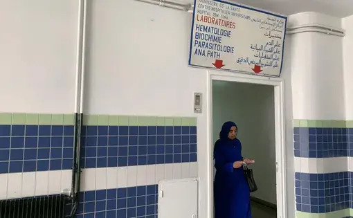A woman walks out of the hematology laboratory in Hôpital Ibn Sina, a public hospital in Rabat and office of doctor and feminist Asma Lamrabet. While Dr. Lamrabet herself does not perform virginity tests, clinics and hospitals such as this one are visited by women to obtain virginity certificates. Image by Samidha Sane. Rabat, Morocco. 2019.