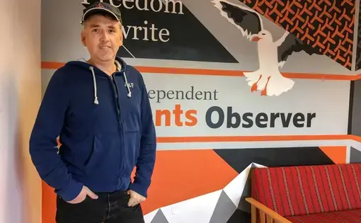 Journalist Thomas Nilsen poses for a photo in the offices of The Barents Observer in Kirkenes, Norway. The newspaper publishes in both English and Russian and covers environmental issues in the Russian Arctic. Nilsen recently found out he was no longer welcome in Russia and he's been fighting the decision in Russian courts. Image by Amy Martin. Norway, 2018.