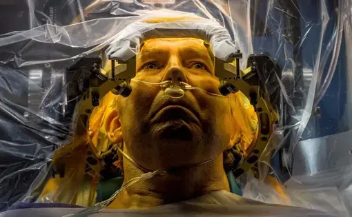 At the University of Florida, Parkinson’s disease patient Russell Price undergoes surgery to implant a deep brain stimulation (DBS) lead that will deliver electrical impulses to motion-controlling parts of his brain, treatment which has been shown to provide substantial relief from symptoms in appropriately selected patients. Additional improvement in some patients may also derive from the mere expectation that the procedure will help—the so-called placebo effect. “It’s not a magical thing,” says neurologis