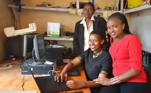 Magdaline Sointa helping run her family's cybercafe with her mom, Louisa, and sister Sylvia.  Image by Janelle Richards. Kenya, 2017.
