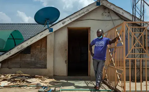 Former Uber driver Harrison Munala on the roof of his former apartment building, which his wife and their three children were evicted from in mid-August after they fell behind on their rent. Image by Nichole Sobecki/NBC News. Kenya, 2020.