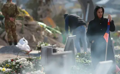 Flowers on the graves of fallen soldiers in Yerablur Military Memorial Cemetery in Yerevan. Image by Gevorg Ghazaryan / Shutterstock. Armenia, 2020.