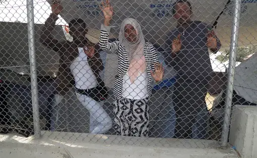 Yassin Abuukar, Kowthar Adraman and Kamal Hassan at Moria refugee camp on Lesbos.  The three Somali journalists seek asylum in Euripe. Image by Jeanne Carstensen. Greece, 2016.