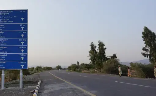 A sign indicating distances in Miran Shah, on the road leading to Afghanistan. Image by Umar Farooq. Pakistan, 2017. 