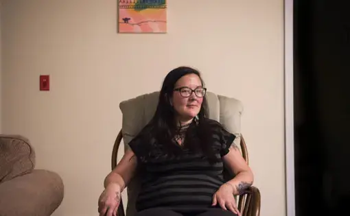 Erin Saunders, 35, at her apartment in the military base town of Happy Valley-Goose Bay, Labrador. Saunders was arrested protesting the construction of a local Canadian hydropower dam, which she says threatens her way of life. Image by Michael G. Seamans. Canada, 2019.