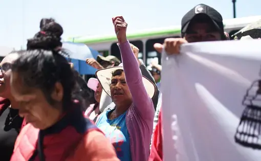 A woman raises her fist during a Mazahua Frente protest in Toluca. The advocacy group demanded to speak with the governor about their concerns. Image by Meg Vatterott. Mexico, 2018.