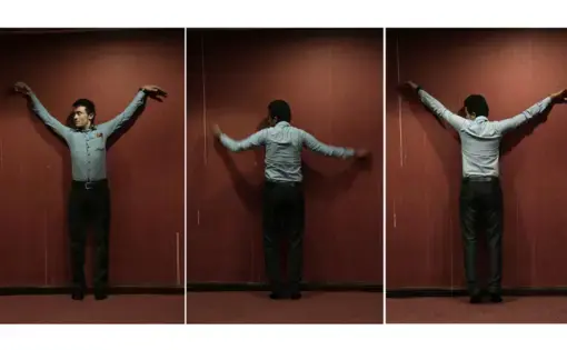 Yemeni medic Farouk Baakar demonstrates how he was shackled to a wall during his torture in a prison run by Yemen’s Houthi rebels. Image by Nariman El-Mofty for AP News. Yemen, 2018.