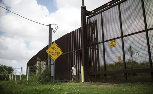 Juan Cavazos of Brownsville, Texas at the electronic gate in the border fence that runs through his property. Image by Martin do Nascimento for The Texas Tribune. United States, 2017. Juan Cavazos of Brownsville, Texas at the electronic gate in the border fence that runs through his property. Image by Martin do Nascimento for The Texas Tribune. United States, 2017.