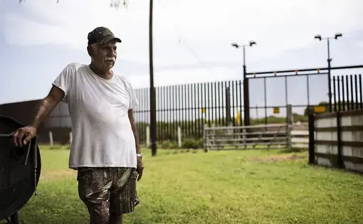 Juan Cavazos at his home on Oklahoma Avenue in Brownsville, Texas. The federal government took part of the former teacher's land to build the border fence. Image by&nbsp;Martin do Nascimento. United States, 2017.
