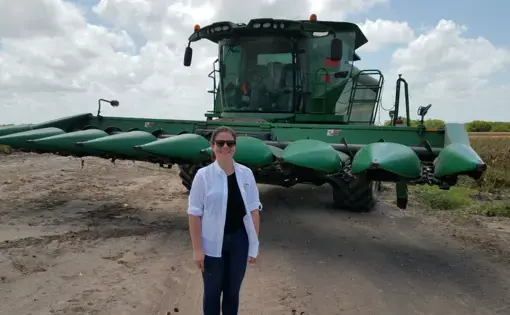 The Texas Tribune’s Kiah Collier poses in front of a combine in the Rio Grande Valley of Texas during a reporting trip for the project. Image by Julián Aguilar. United States, 2017.