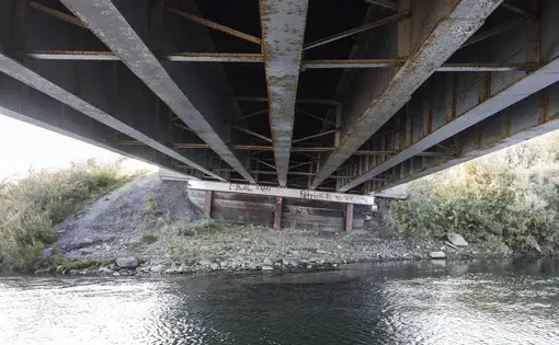 Thawing permafrost has caused a tilt on the pilings that support this bridge on the Nome-Teller Highway, requiring increased maintenance as the Northwest Alaska climate warms. Image by Steve Ringman. United States, 2019.