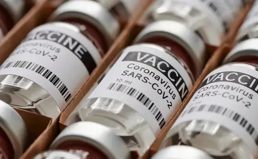 Ampoules containing coronavirus vaccine. Image by M-Foto / Shutterstock. 2020.