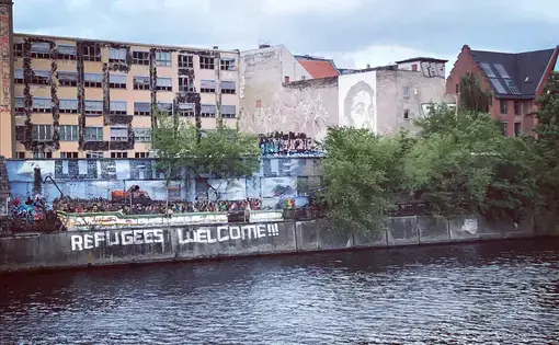 "Refugees Welcome" reads graffiti in one part of Berlin, Germany, the country that took in the most asylum seekers during the 2015 refugee crisis. Image by Alice Su. Germany, 2017. "Refugees Welcome" reads graffiti in one part of Berlin, Germany, the country that took in the most asylum seekers during the 2015 refugee crisis. Image by Alice Su. Germany, 2017.