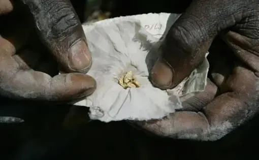 A miner shows off a piece of gold. Image by Carlos Villalon. Democratic Republic of Congo, 2006.