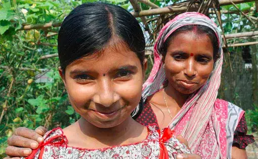 Suchitra Dey with her daughter, Tulsi (left), after Dey received rights to her plot of land in West Bengal. Image courtesy Landesa. India.