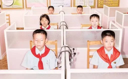 Students at the Pyongyang Orphans’ Secondary School, which is housed in a new brick-and-steel complex. In a class of ten- and eleven-year-olds, one boy asked, “Why is America trying to provoke a war with us?” Image by Max Pinckers/The New Yorker. North Korea, 2017.