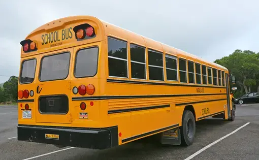 Yellow school bus at a parking lot in San Antonio, Texas. Image by Kokoulina / Shutterstock. United States, 2016.