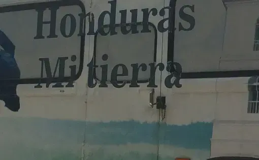 A bus in San Pedro Sula awaits deportees from detention centers in the US. Image by Emily Gogolak. United States, 2016.