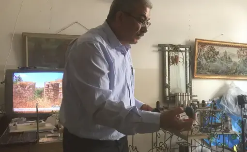 Investigator Iyad Haddad explains the injuries the different spent weapons in his office have done to Palestinians. Image by Matt Kennard. Palestine, 2016.