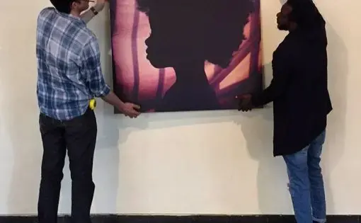A photo from Everyday Africa is hung at an exhibition in Nairobi. Image courtesy of Peter DiCampo. Kenya, 2017.