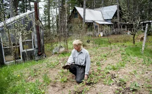 Duane Hanson checks the soil of his garden as prepares for the new growing season at his homestead in the Unorganized Territories in the north woods of Maine near T5 R7 on May 27, 2019. Image by Michael G. Seamans. United States, 2019.
