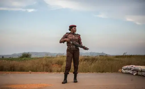 Vigilante Sarah Dung, 39, guards a checkpoint. Image by Jane Hahn. Nigeria, 2018.