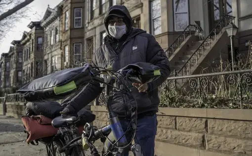 Ripon stands next to his delivery bike in Brooklyn. Image by Bruno Federico. United States, 2021.