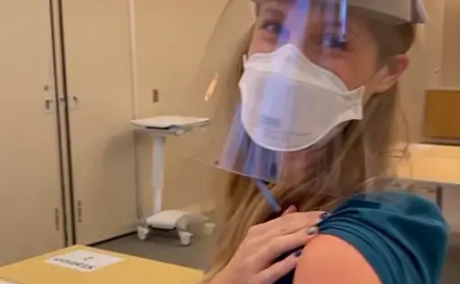 Kate smiles after receiving the first dose of the Pfizer-BioNTech COVID-19 vaccine in December. Image courtesy of Kate. United States, 2020.