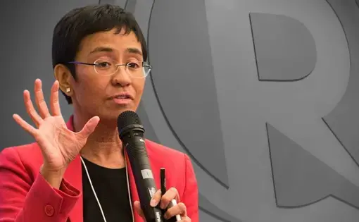 Maria Ressa speaks into a microphone