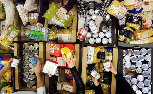 Trussell Trust volunteers sort through food. Image courtesy of Trussell Trust. United Kingdom, undated.
