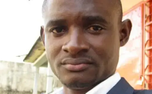Pulitzer Center grantee Christian Locked dressed in a suit.