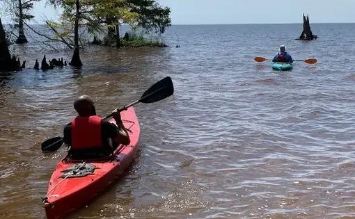 Bertie County Manager Juan Vaughan II and retired county manager Scott Sauer take to the water during the Bertie Beach grand opening in June 2019. (Sarah Tinkham/TGOW)