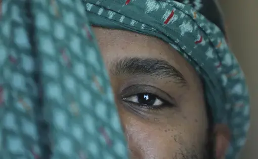 A close-up portrait of a man, with a focus on his eye.