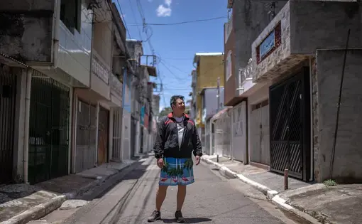 Portrait of person standing in a city street.