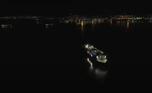 Aerial drone footage of a cruise ship at night