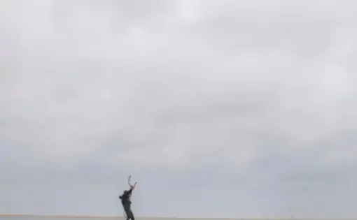 A man parasailing on the water.
