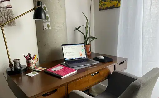 Aerial view of a desk with a laptop open.