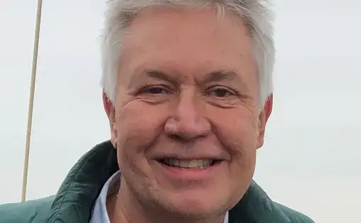 Jon Sawyer stands next to a bay