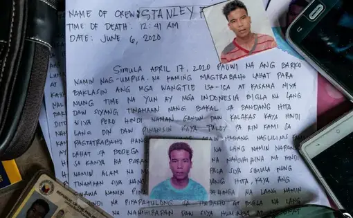 Image of a piece of paper that details the death of Stanley on June 6, 2020, written in Filipino. Placed on top of the paper are three small headshots of Stanley, his ID, and two cell phones.