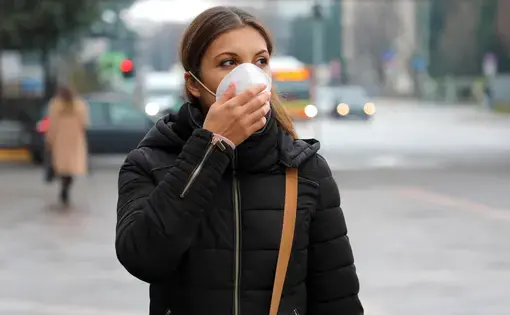 Girl with protective mask on face against Coronavirus Disease 2019
