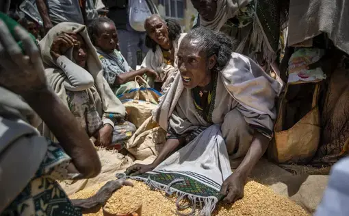 A woman argues with others over the allocation of yellow split peas in Tigray, northern Ethiopia.
