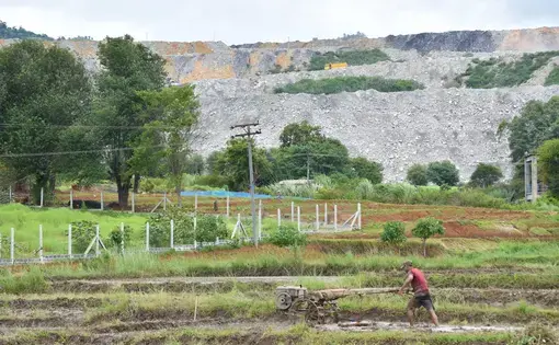 A farmer works in a field near a coal mining site in Tigyit. Photo: Robert Bociaga
