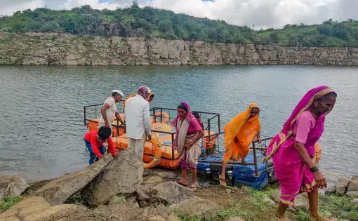 photo of people on bank of river