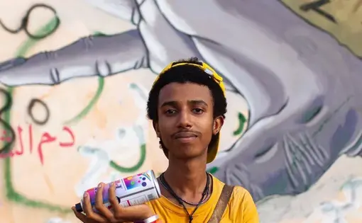 Man in front of mural